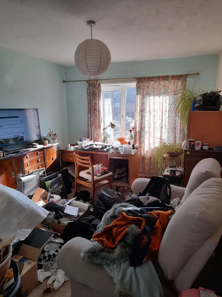 cluttered house with lots of mess all over the floor and old furniture around the room waiting for full house clearance services from mangrove pwc