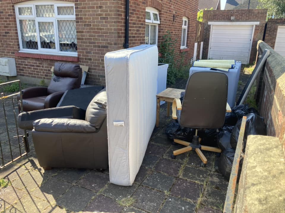 household furniture waiting outside of the house waiting for rubbish removal and eco-friendly disposal