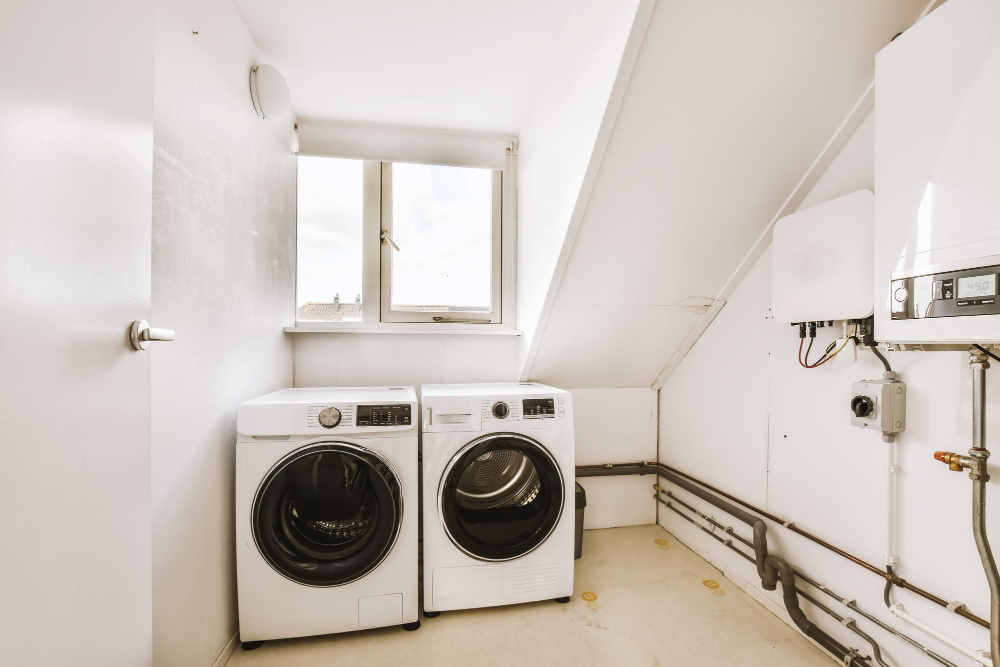 old washing machine next to old dryer waiting to be removed and replaced