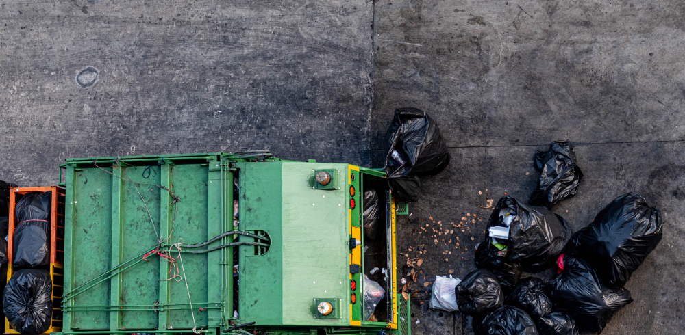 green waste removal van collecting black bin bags